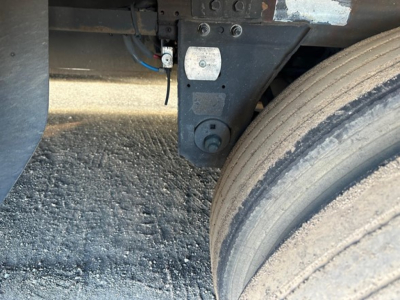 Trailer undercarriage showing air line fitting and suspension mount near dual rear tires of a 2019 Utility 3000R reefer trailer.