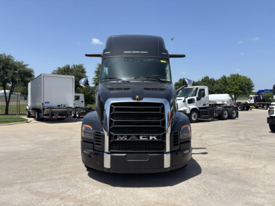 Front view of a black Mack truck cab showing the grille with 'MACK' badge, large bumper, and headlights; no other readable labels visible.
