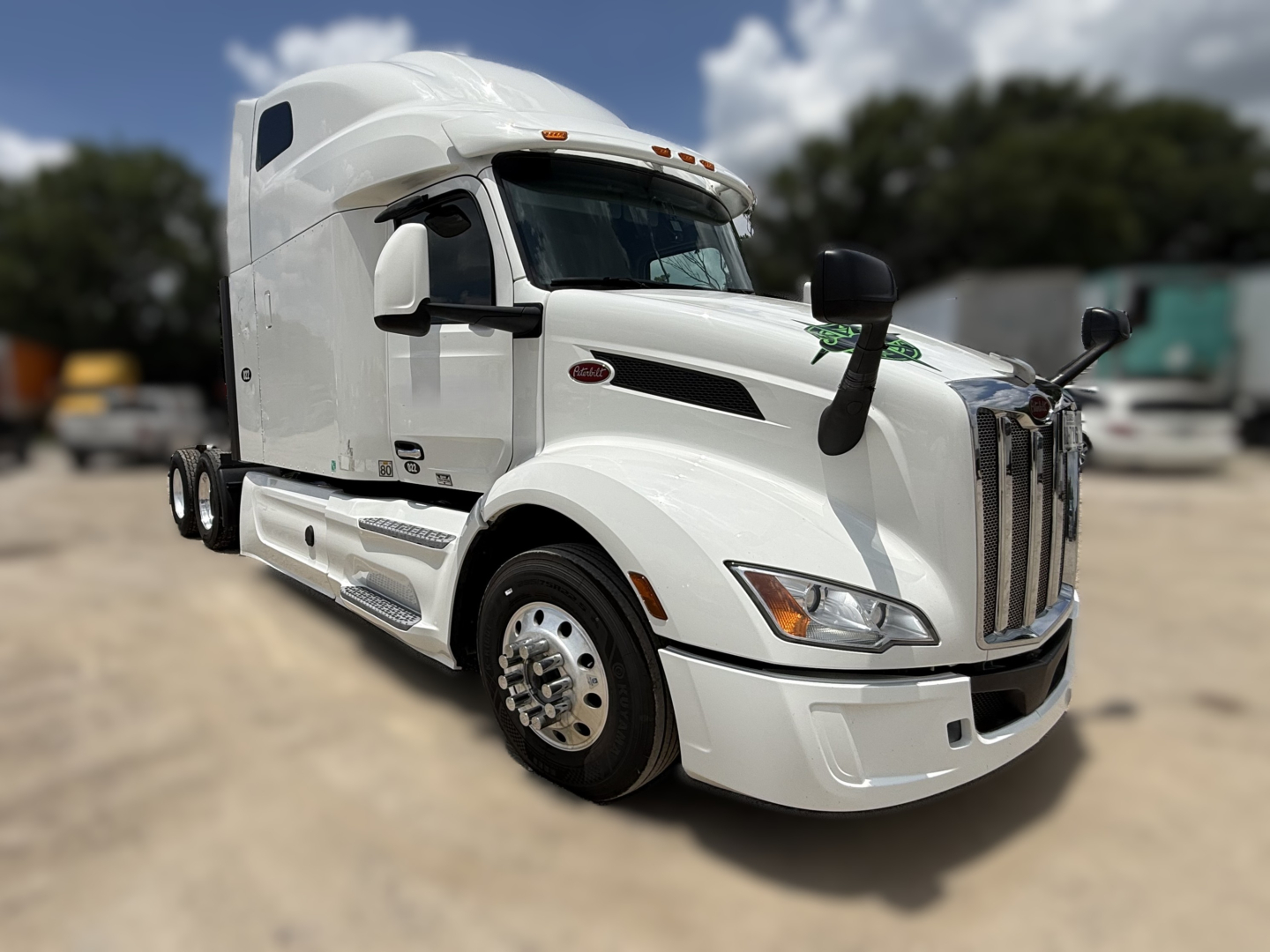 Peterbilt 579 conventional sleeper truck in white, front-left view, chrome grille, dual rear wheels, day cab style, stock photo of used vehicle.
