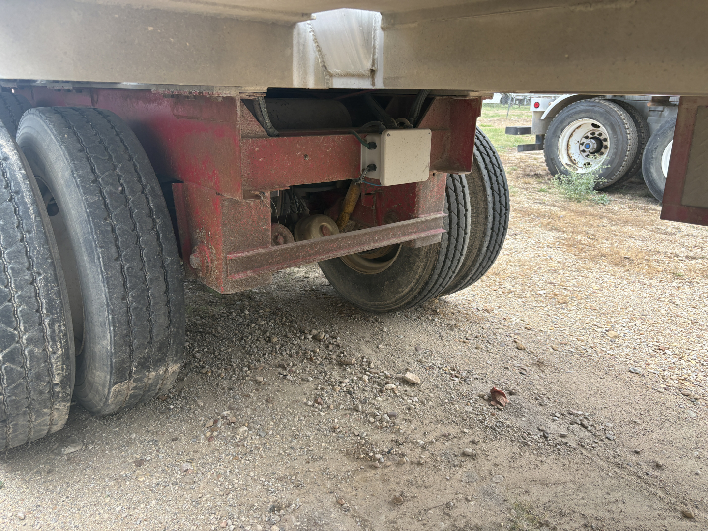 Rear view of a 2012 Dragon vacuum trailer showing dual rear wheels and undercarriage hitch assembly.