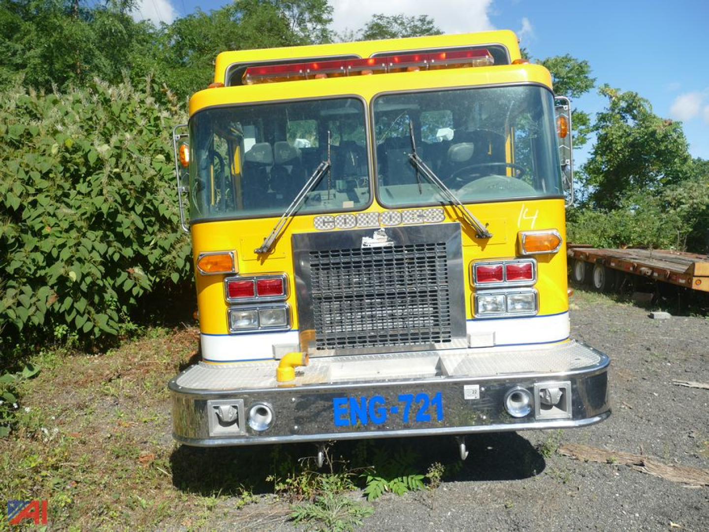 Front view of a yellow 1995 Spartan Gladiator fire truck with ENG-721 plate and large grille, two windshield wipers, and side mirrors.
