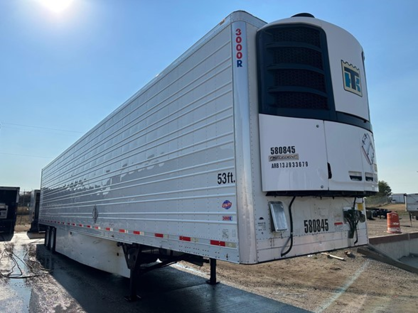 Trailer side view showing Thermo King reefer unit on front, 2015 Utility S-600 with brand markings and stock numbers visible