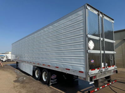 Trailer side and rear showing aluminum box truck trailer with dual rear doors and diamond plate end; three axles and reefer category trailer visible.