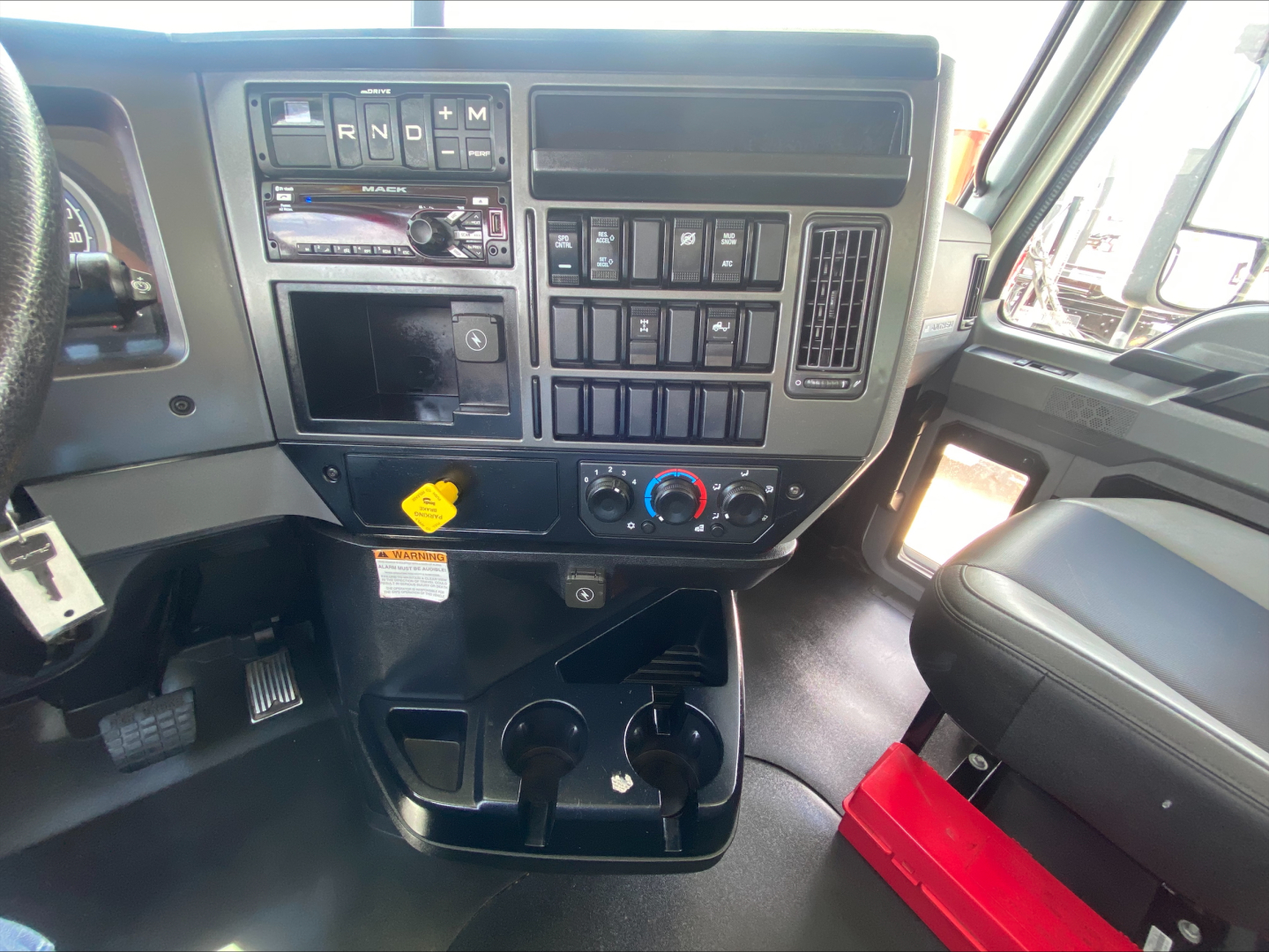 Dashboard interior of 2019 Mack AN64 truck showing steering, control panel, and center console with various switches and climate controls.