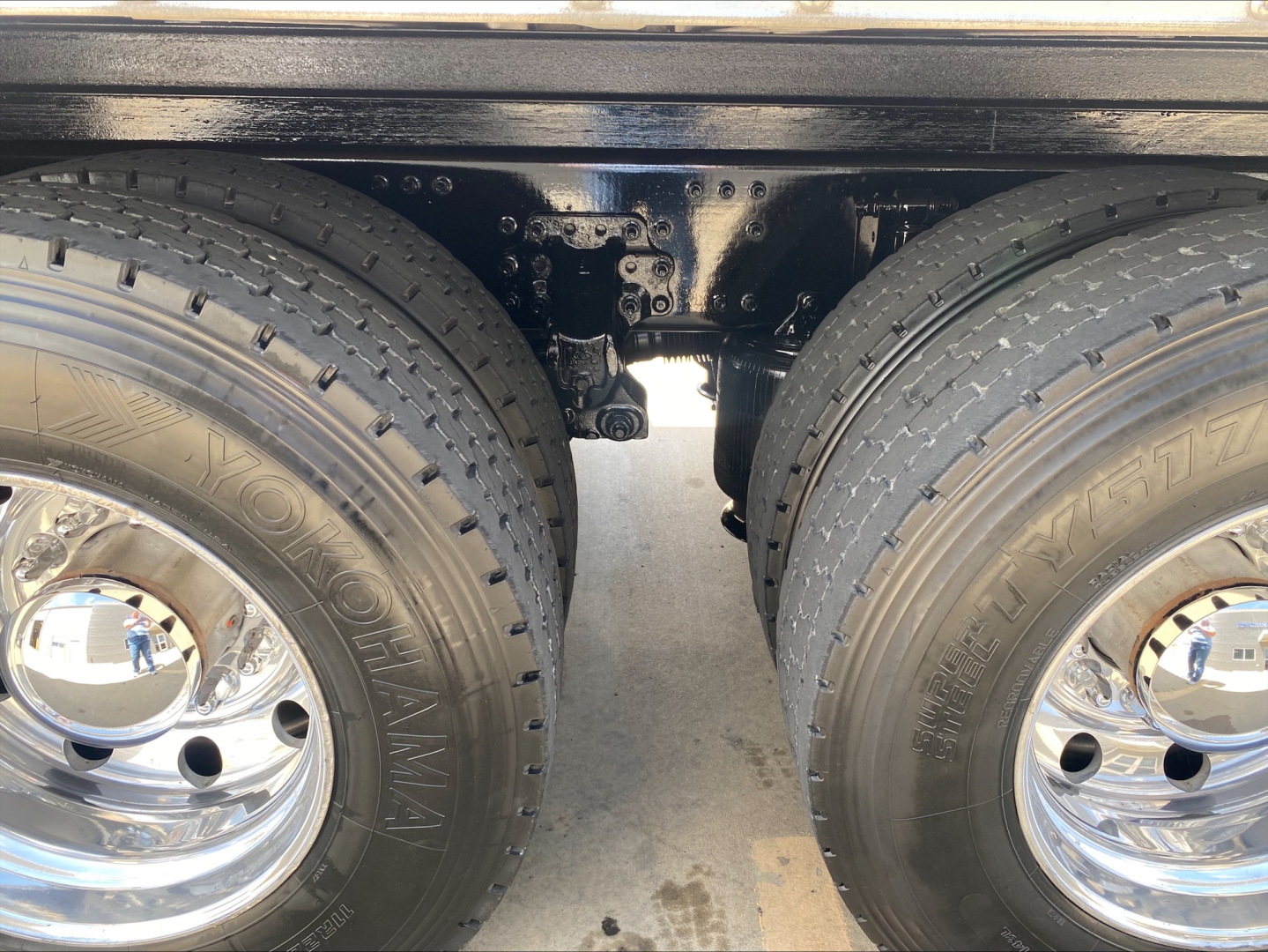 Mack AN64 truck rear dual tires showing chassis and leaf spring area, with Yokohama tires and chrome wheels visible.