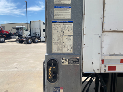 Panel with safety instructions and a lever on a Mack AN64 truck trailer. Visible text includes MA N at the lever and a diagram label with small instruction panels.