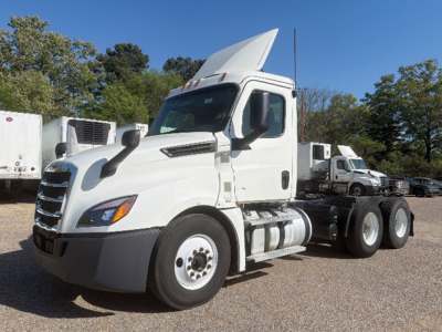 Truck cab and chassis: 2020 Freightliner Cascadia126 daytime view showing white exterior, diesel fuel tanks, and dual rear axles.