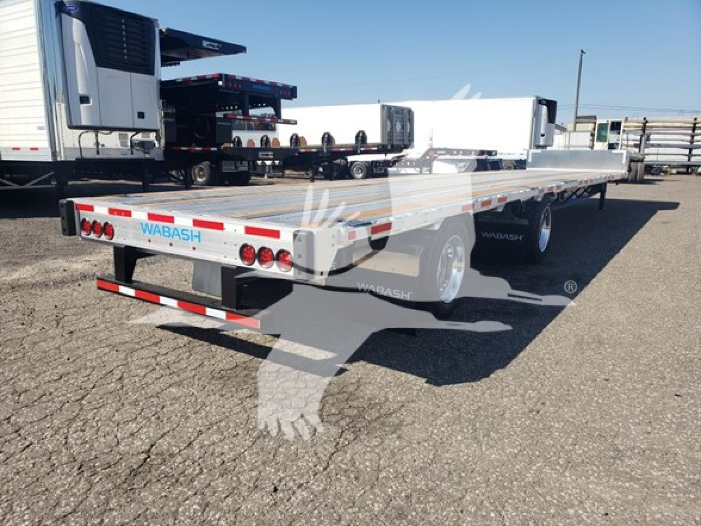 Wabash Combo Low Pro 17.5 trailer side and rear view showing aluminum flatbed, rear lights, and branding