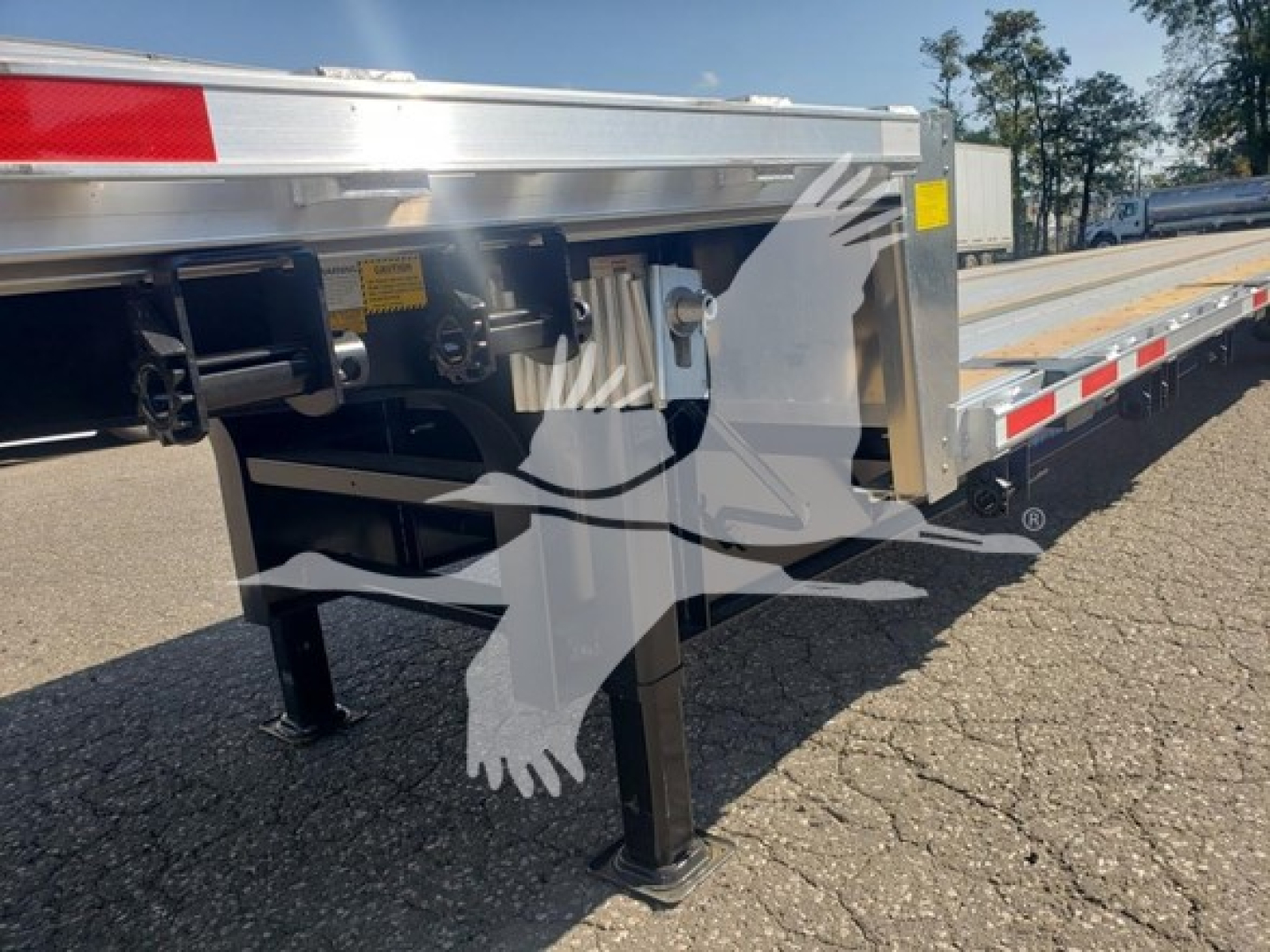 Trailer leg and frame of a 2024 Wabash Combo Low Pro 17.5 trailer showing landing legs and side rail with connectors.
