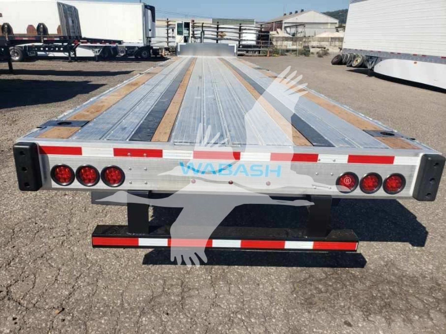 Wabash combo low pro 17.5 trailer flatbed rear view showing taillights and reflective tape