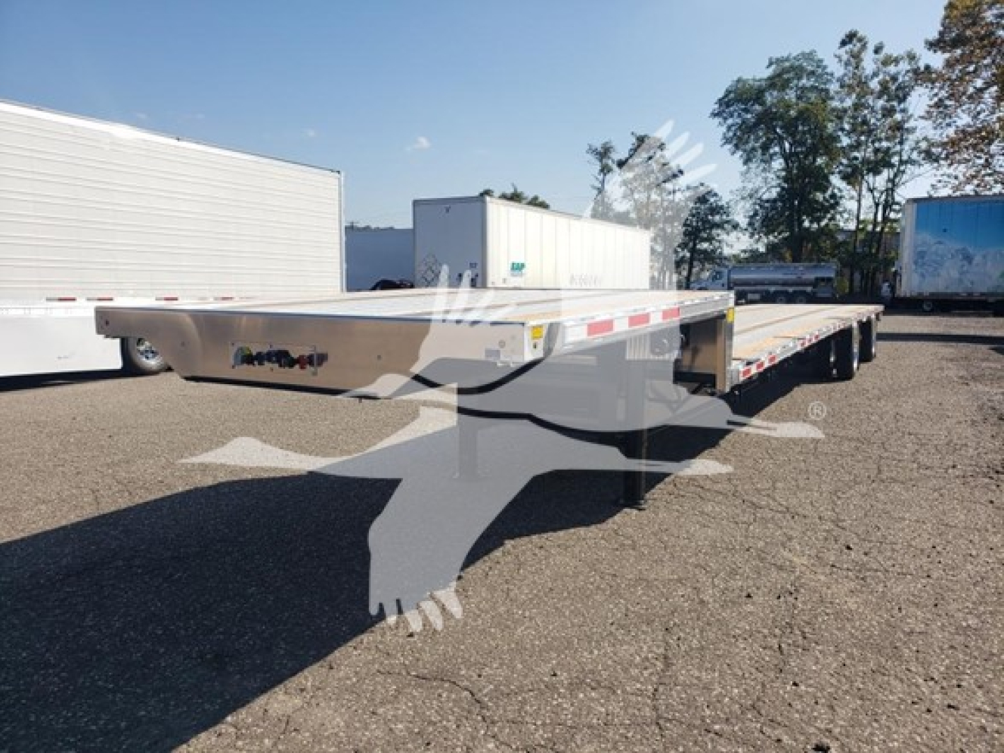 Trailer in a parking lot showing low pro 17.5 combo flatbed with Wabash branding and reflective tape along the sides.