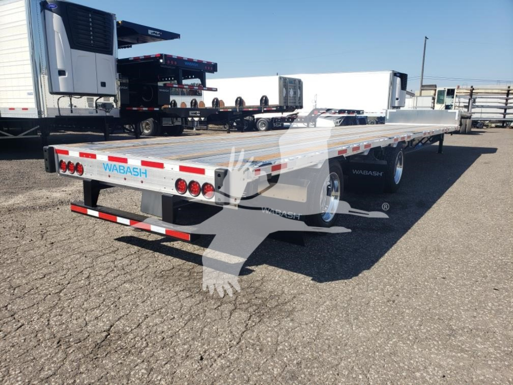 Wabash combo low pro 17.5 trailer rear view showingSafety lights and metal deck with white and blue WABASH branding.