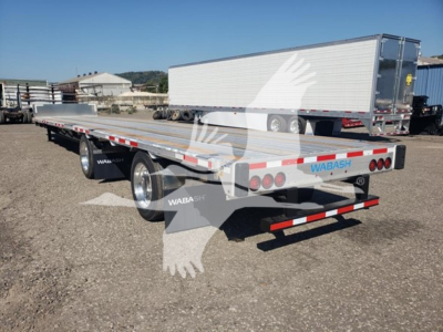 Trailer showing rear and side view of a Wabash drop deck trailer with low pro design, dual rear axles, and reflective safety tape.