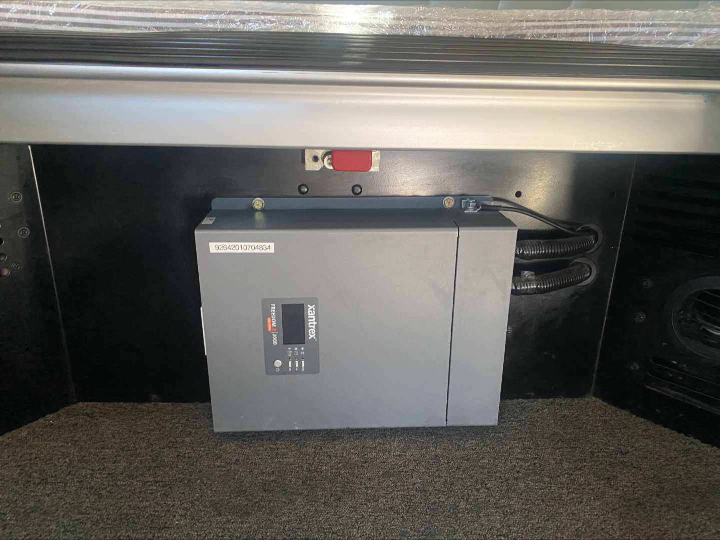 Truck cab area showing electrical control box mounted in rear compartment.