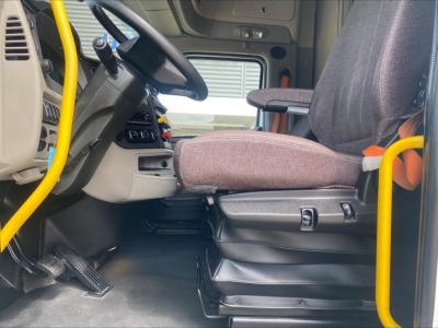 Peterbilt 579 cabin interior showing driver's seat and steering wheel area with controls