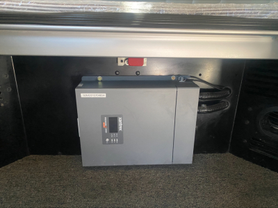 Truck cab area showing electrical control box mounted in rear compartment.