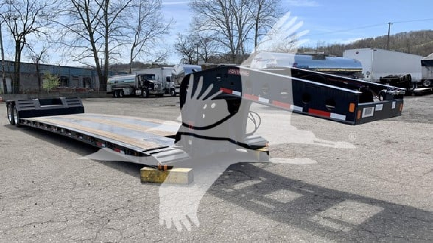 Fontaine Renegade N12 lowboy trailer showing aluminum deck and gooseneck configuration with branding and trailer components.