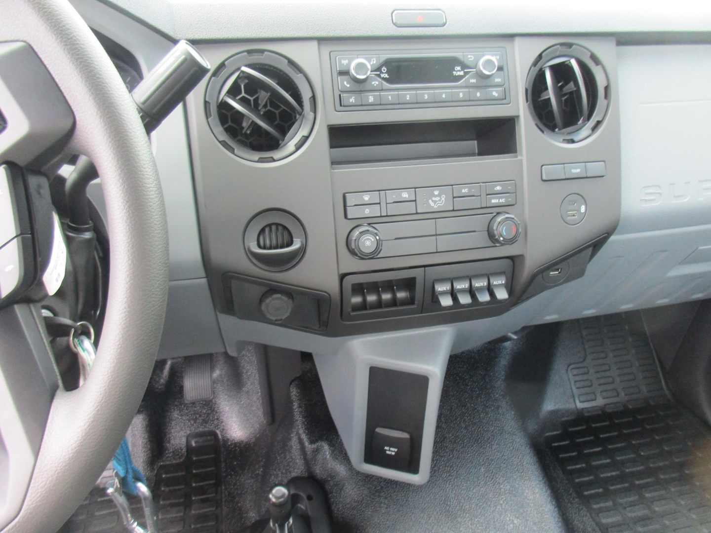 Ford F-650 interior dashboard and center console showing HVAC controls and audio head unit.
