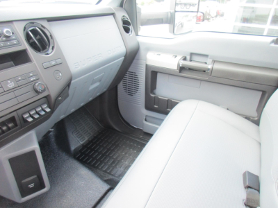 Ford F-650 SD cab interior showing dashboard passenger side and front bench seat with gray trim and floor mats.