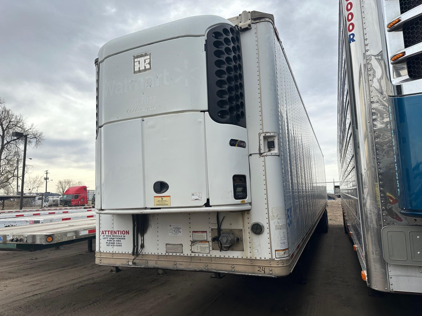Great Dane reefer trailer rear view showing Thermo King unit, rear doors, and labeling. Visible text includes ATTENTION and warning stickers on the lower rear panel.