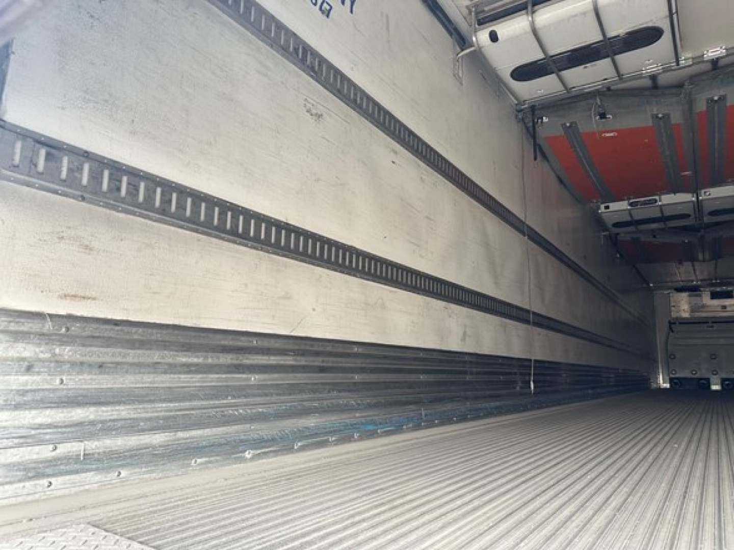 Great Dane reefer trailer interior showing side rails, ribbed walls, and empty cargo floor.