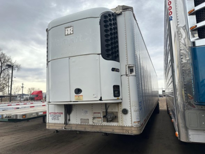 Trailer rear view showing a Great Dane roll door multi temp reefer with large side cooling unit, white exterior, stock number UE10775, VIN 150114098700