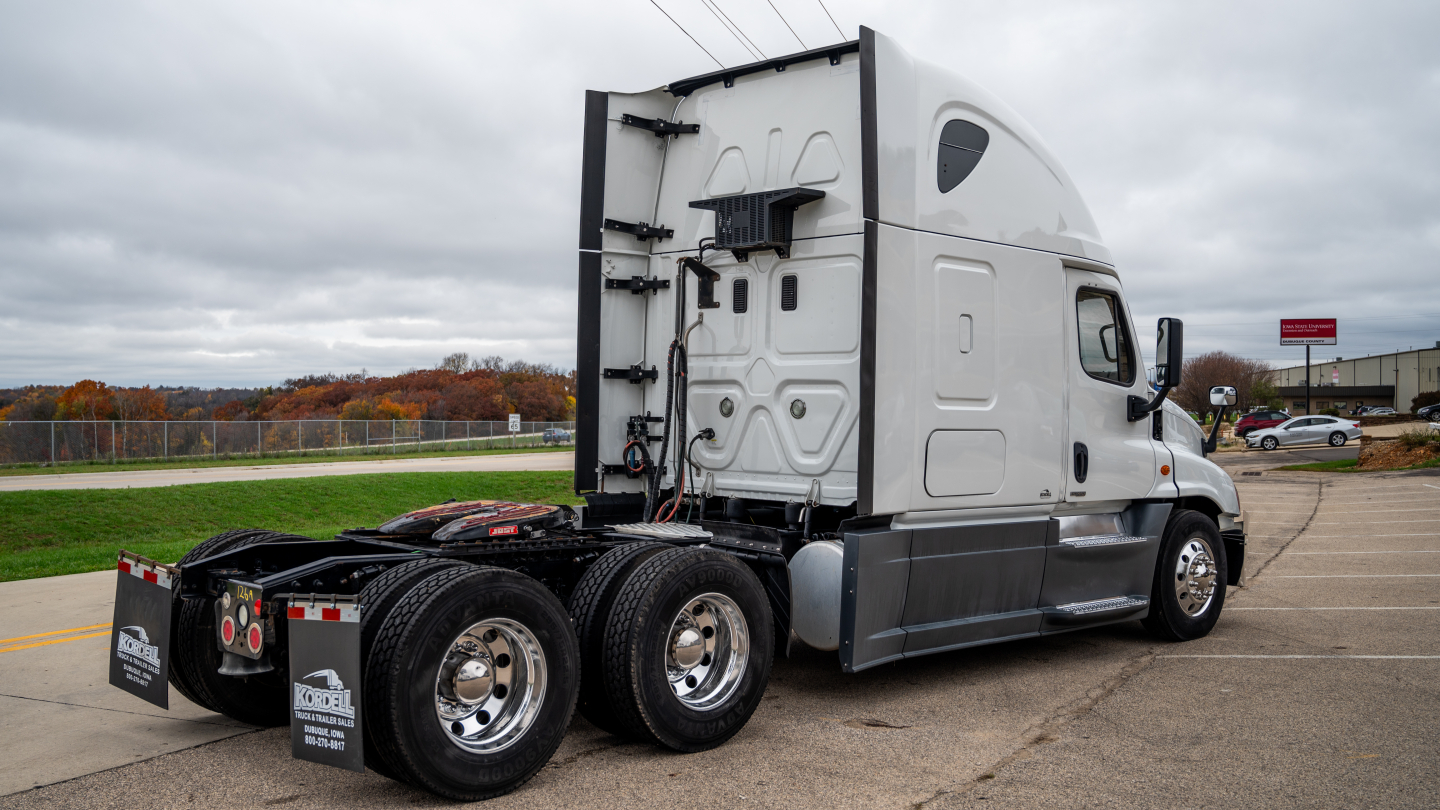 2016 Freightliner Cascadia 125 tractor truck rear three-quarter view showing sleeper cab and dual rear axles