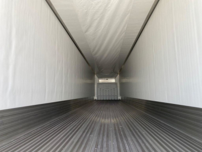 Trailer interior view of a new 2027 Utility reefer, empty cargo area with clean white walls and ribbed metal floor.
