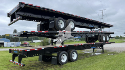 Wabash Air Slider trailer stacked on dual trailers showing wheels and underside with reflectors and support frames.
