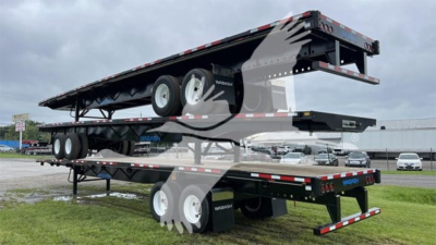 Flatbed trailer with Wabash Steel Air Slider in stacked position showing axles and frame in-service