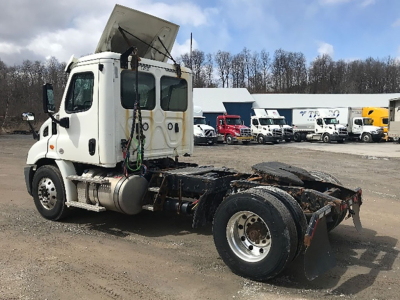 Freightliner Cascadia Daycab tractor tractor chassis and cab view with raised sleeper door and rear wheel area visible.