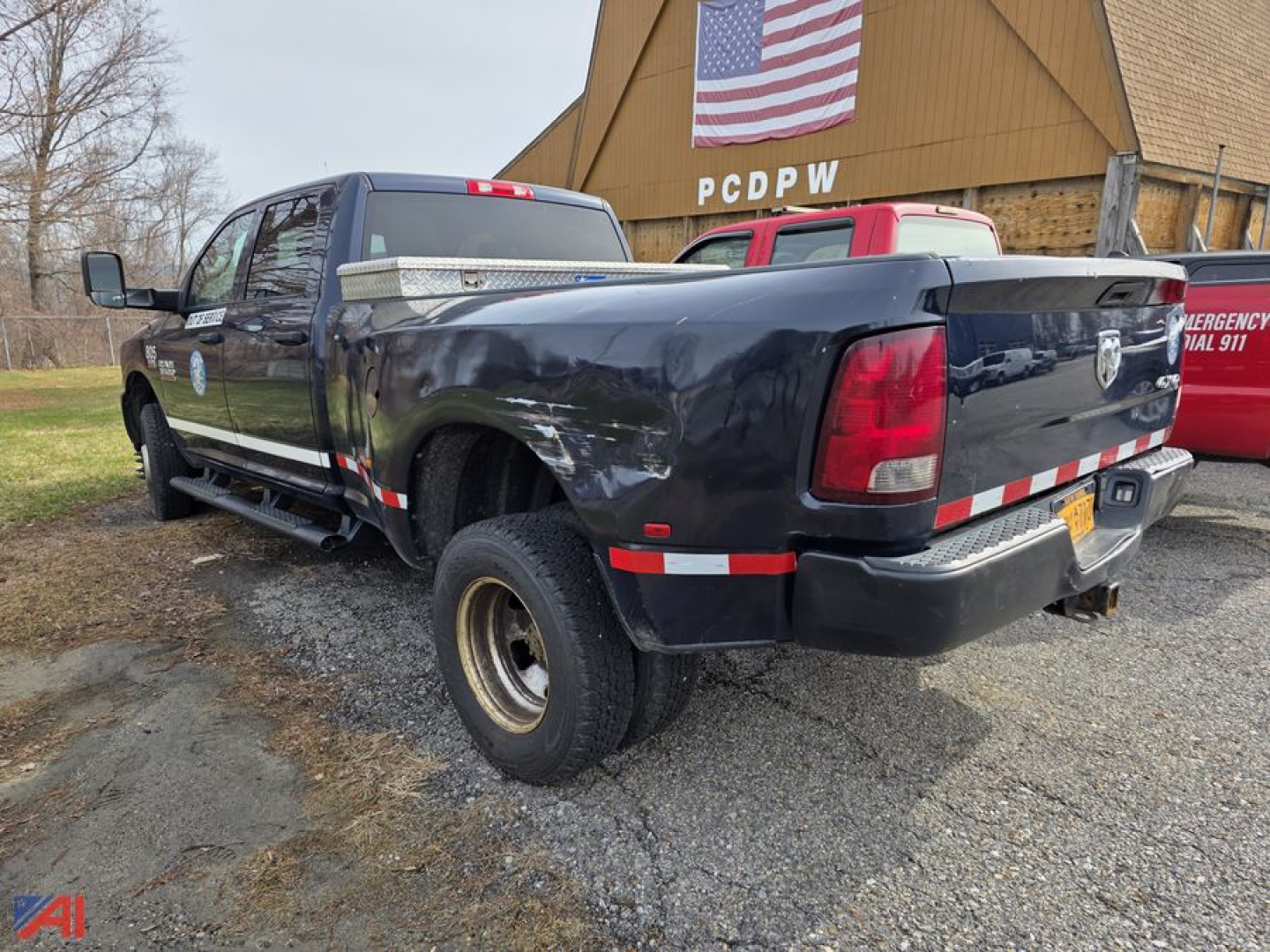 2017 Ram 3500 pickup truck in serviceable condition shown from rear passenger side with extended cab, long bed, dual rear tires, and reflective safety stripes on bed.