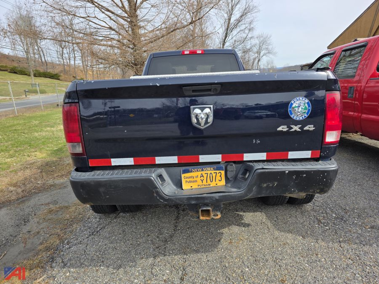 Ram 3500 pickup rear view showing tailgate with RAM badge, 4x4 badge, rear bumper, and yellow license plate.