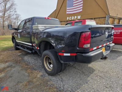 2017 Ram 3500 pickup truck in serviceable condition shown from rear passenger side with extended cab, long bed, dual rear tires, and reflective safety stripes on bed.