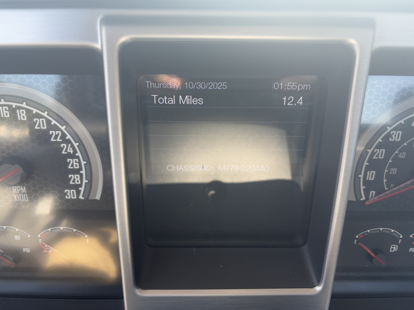 Mack PI64T truck dashboard display showing total miles 12.4, date Thursday 10/30/2025, time 01:56pm, with instrument clusters on left and right.