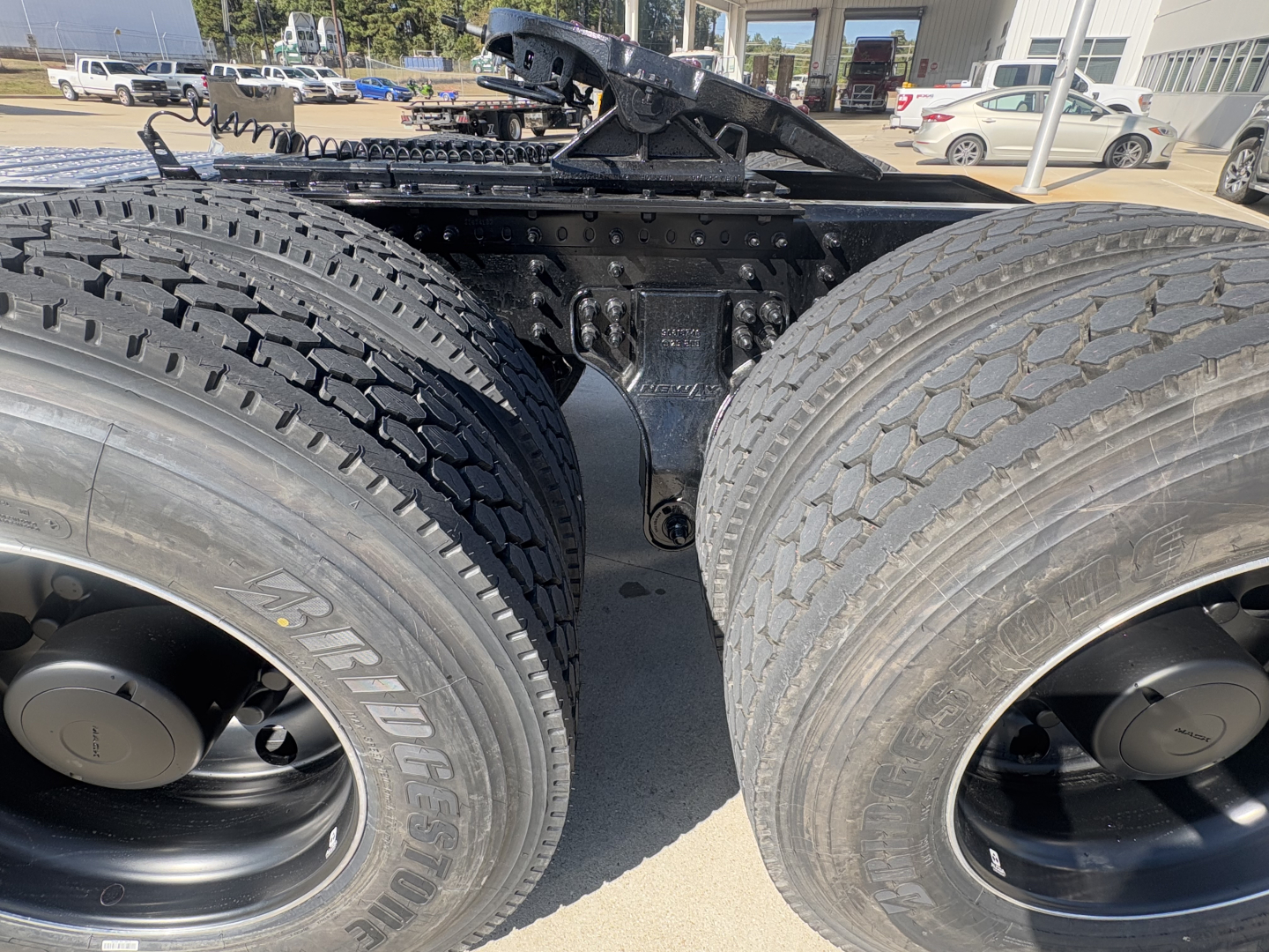Mack PI64T truck dual rear wheels view showing chassis and suspension components and tires.