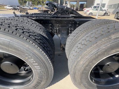 Mack PI64T truck dual rear wheels view showing chassis and suspension components and tires.
