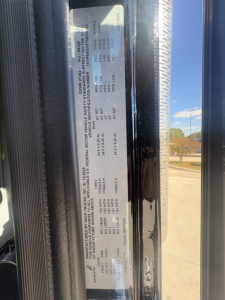 Label with vehicle specifications on Mack PI64T side door area showing VIN, engine, and weight details.