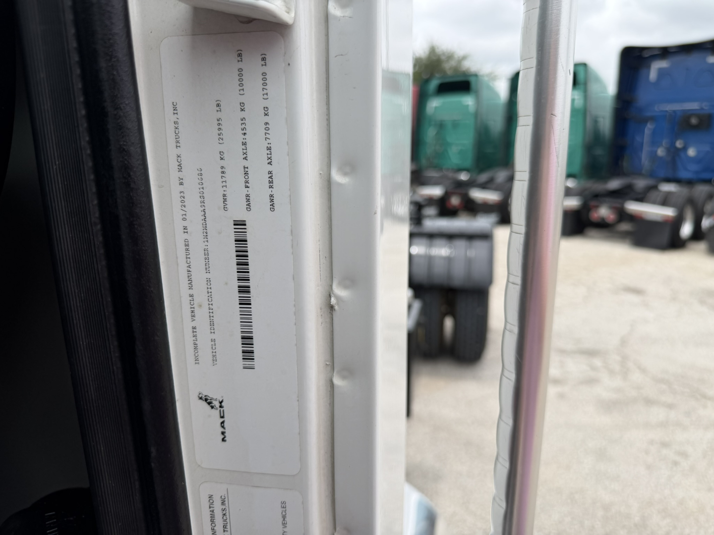 Mack MD6 truck door area with VIN sticker and barcode visible on the door jam.