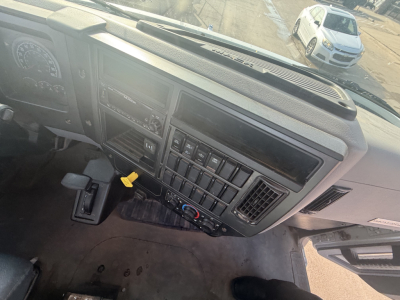 Dashboard view of a Mack MD6 truck interior showing instrument cluster, center console, switches, and steering column.