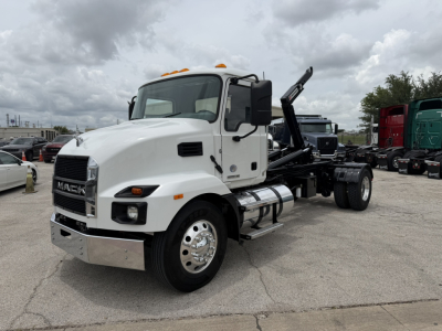 Mack MD6 hooklift truck in service showing front and side cab with white paint and chrome bumper.
