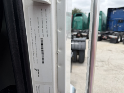 Mack MD6 truck door area with VIN sticker and barcode visible on the door jam.