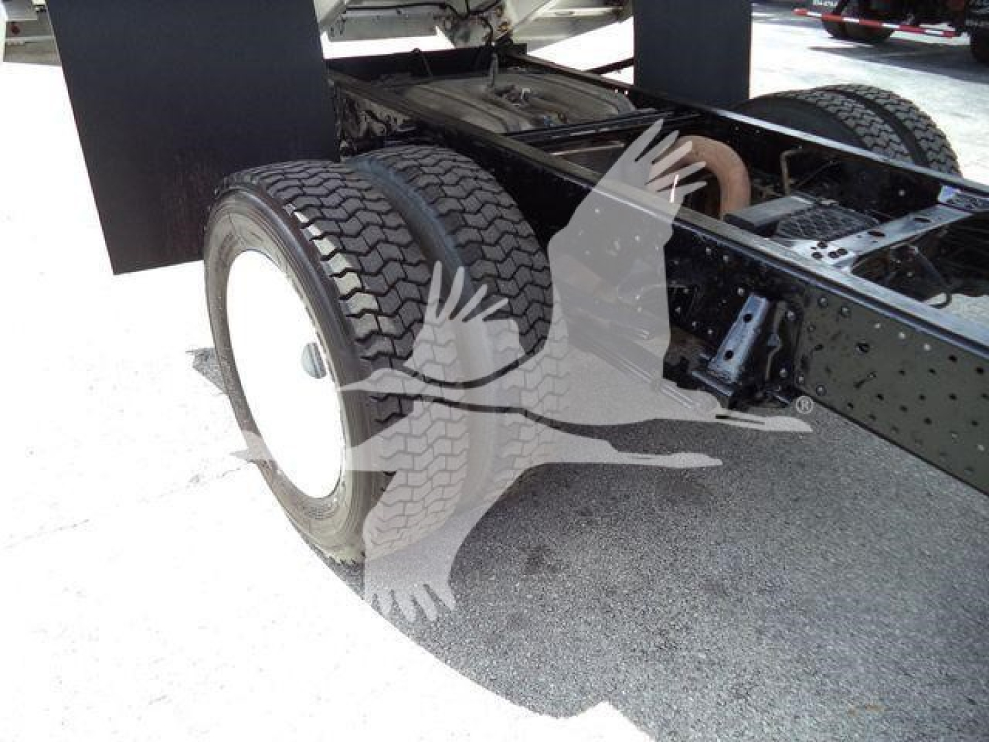 Isuzu NPR HD truck chassis showing dual rear wheels and frame with tires and suspension components.