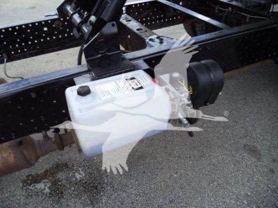 Isuzu NPR HD chassis showing coolant reservoir and undercarriage components
