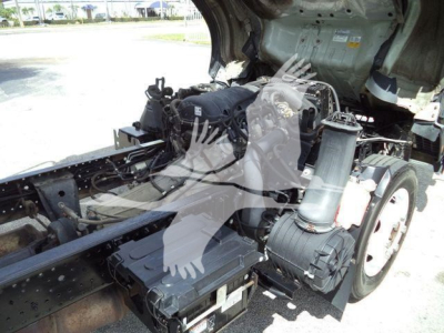 Isuzu NPR HD truck engine bay showing large air intake, coolant reservoir, and various components. visible text on labels is not legible.