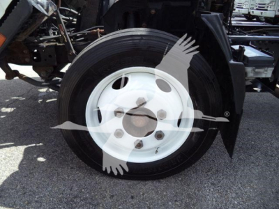 Isuzu NPR HD truck wheel and dual rear fender area with white steel wheel and tire, part of heavy-duty chassis