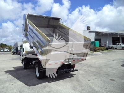 Isuzu NPR-HD dump truck rear view with raised dump bed and hydraulic system visible.