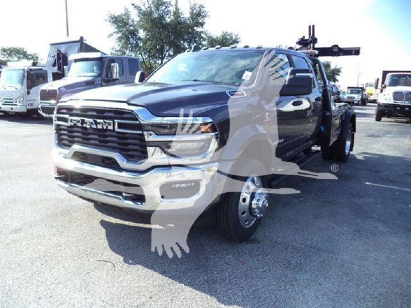 Ram heavy-duty pickup truck in a lot, front three-quarter view, diesel tow setup visible, chrome grille, large RAM badge