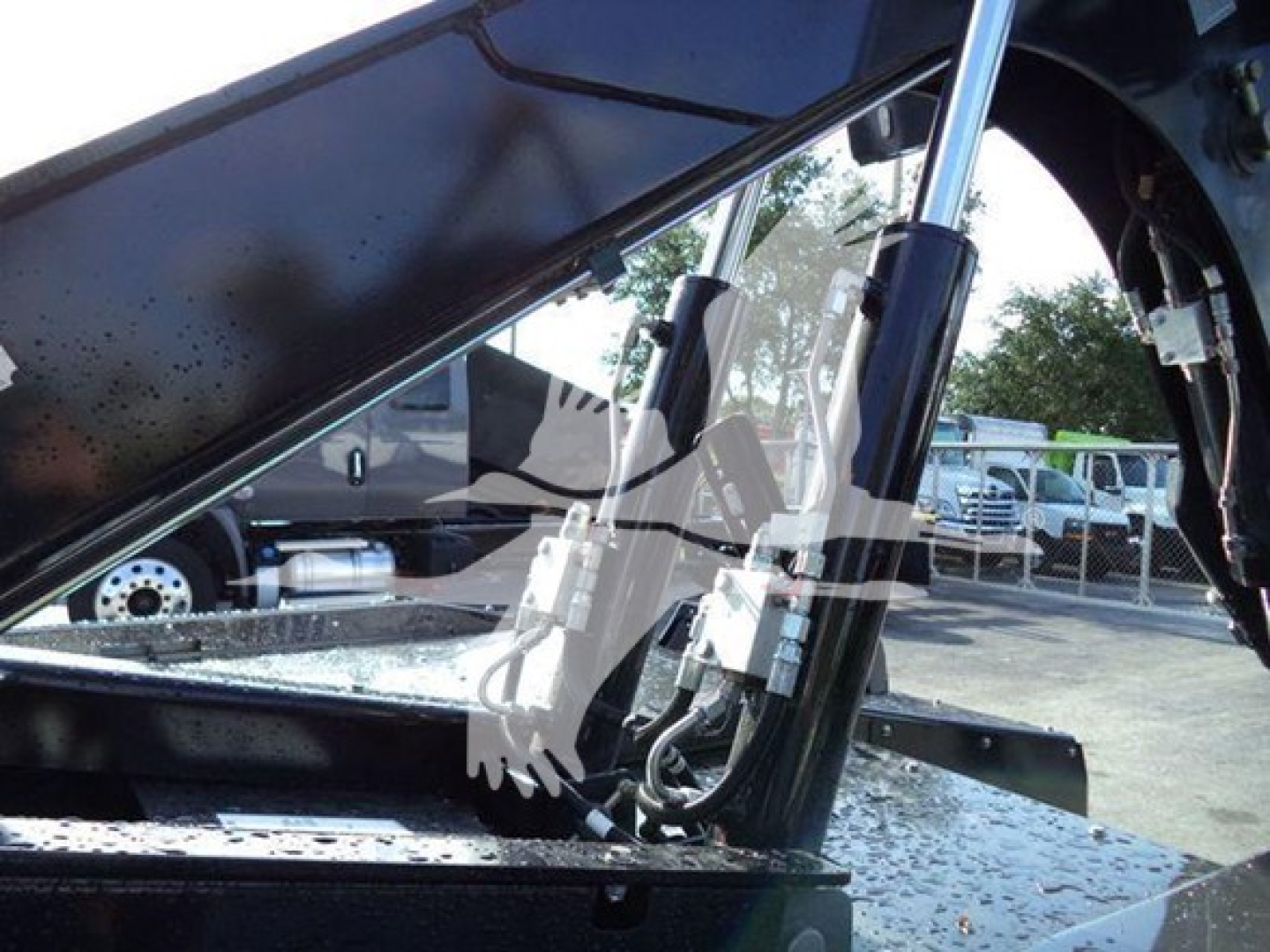 Ram Big Horn truck winch system showing hydraulic lines and hydraulic cylinder under hood area.