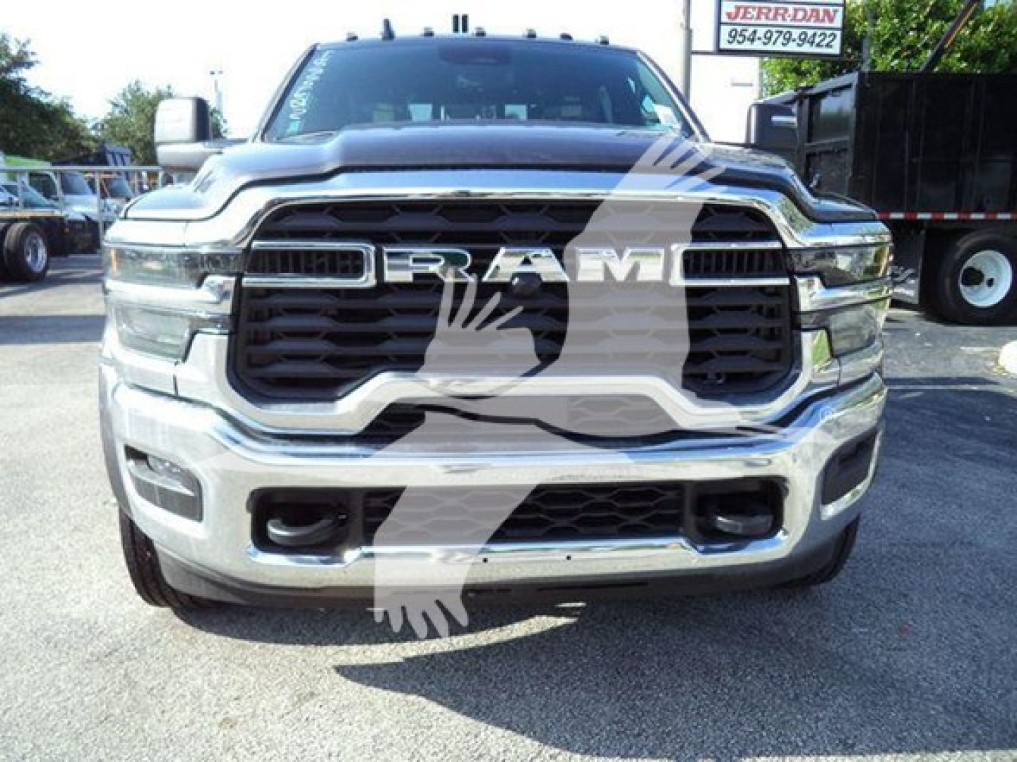 Ram truck front view showing chrome grille and large RAM emblem badge with winch category vehicle badge visible.